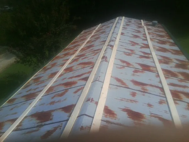 Rusted metal roof panels with new wood purlins before replacement — Storm Damage Roof Repair in Peterborough by Roofing Brothers
